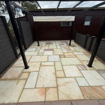 Buff Sandstone Patio Under a Steel Pergola at a Lodge