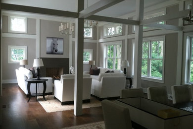 Example of a mid-sized trendy formal and open concept dark wood floor and brown floor living room design in New York with beige walls, a standard fireplace, a metal fireplace and no tv