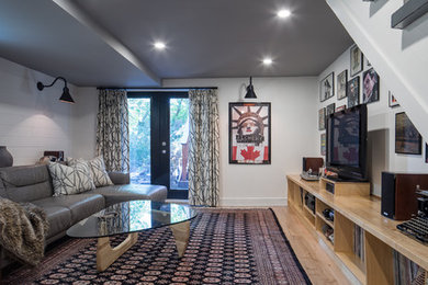 Example of a mid-sized trendy walk-out light wood floor basement design in Ottawa with gray walls