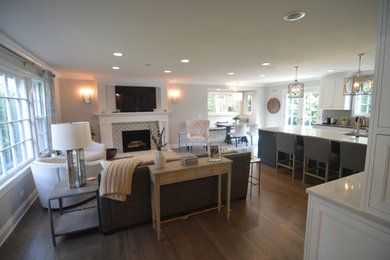 Example of a large transitional medium tone wood floor eat-in kitchen design in Chicago with an undermount sink, recessed-panel cabinets, white cabinets, quartz countertops, gray backsplash, ceramic backsplash, paneled appliances and an island