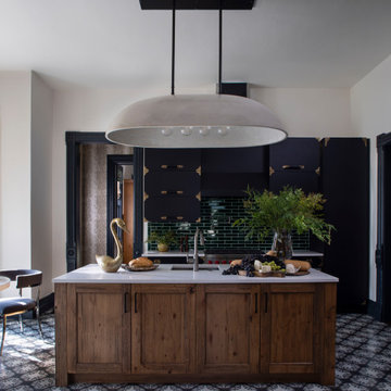 Modern Black Kitchen with Wood Island and Large Cement Chandelier