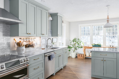 Inspiration for a large farmhouse galley medium tone wood floor and brown floor eat-in kitchen remodel in Boston with an undermount sink, shaker cabinets, green cabinets, quartz countertops, gray backsplash, quartz backsplash, stainless steel appliances, a peninsula and gray countertops