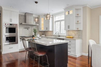 Eat-in kitchen - transitional u-shaped dark wood floor eat-in kitchen idea in Boston with an undermount sink, shaker cabinets, white cabinets, quartzite countertops, beige backsplash, stainless steel appliances, an island and beige countertops