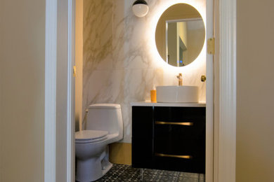 Powder room - small contemporary porcelain tile porcelain tile powder room idea in Ottawa with flat-panel cabinets, black cabinets, a one-piece toilet, a vessel sink and quartz countertops