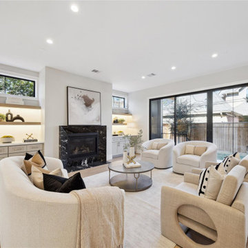 Neutral living room with linear fireplace and built-in shelving