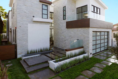 Inspiration for a large modern white two-story stucco flat roof remodel in Los Angeles