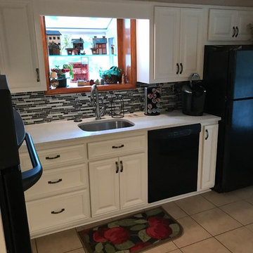 cabinet refacing--white with quartz countertops and glass backsplash