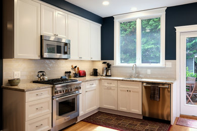 Example of a mid-sized arts and crafts u-shaped light wood floor and brown floor eat-in kitchen design in Baltimore with an undermount sink, recessed-panel cabinets, white cabinets, granite countertops, white backsplash, ceramic backsplash and gray countertops
