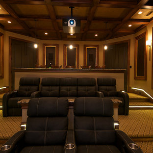 Example of a mid-sized mountain style enclosed carpeted home theater design in Raleigh with brown walls and a projector screen