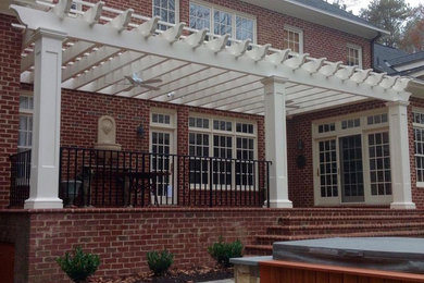 Patio - mid-sized traditional backyard brick patio idea in Richmond with a pergola