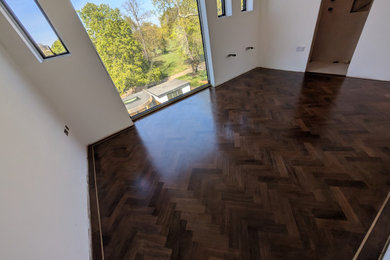 Inspiration for a large traditional bedroom in London with dark hardwood flooring.