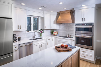 Inspiration for a small transitional l-shaped light wood floor and brown floor eat-in kitchen remodel in Other with an undermount sink, shaker cabinets, light wood cabinets, quartz countertops, white backsplash, porcelain backsplash, stainless steel appliances, an island and white countertops