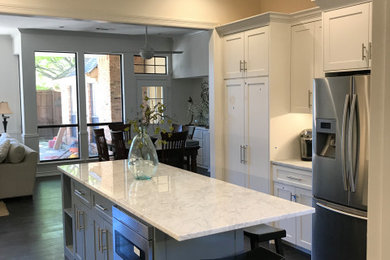 Kitchen pantry - large transitional u-shaped dark wood floor, brown floor and vaulted ceiling kitchen pantry idea in Dallas with a farmhouse sink, shaker cabinets, white cabinets, marble countertops, blue backsplash, glass tile backsplash, stainless steel appliances, an island and white countertops
