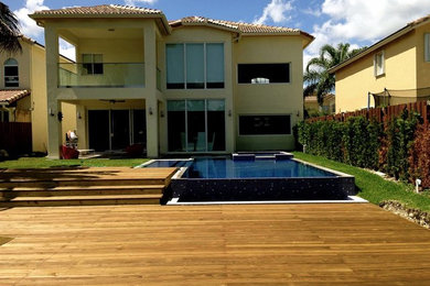 Example of a large transitional yellow two-story stucco exterior home design in Miami