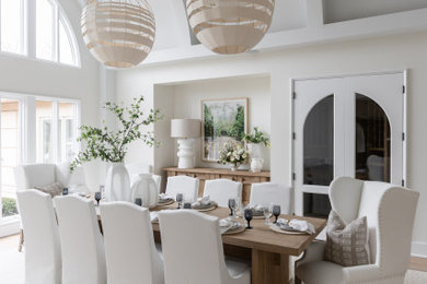 Dining room - large coastal medium tone wood floor, brown floor and vaulted ceiling dining room idea in Nashville with white walls
