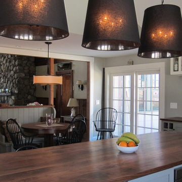 Wood Kitchen Island with Statement Pendant Lighting and Open Dining Connection –