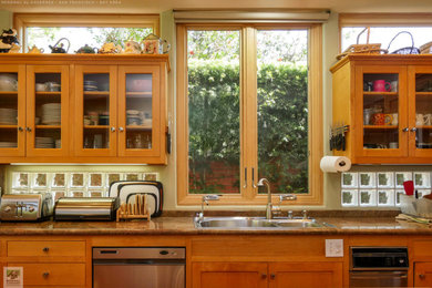 Large l-shaped medium tone wood floor and vaulted ceiling eat-in kitchen photo in San Francisco with a double-bowl sink, medium tone wood cabinets, granite countertops, stainless steel appliances, an island and brown countertops