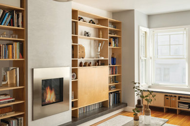 Living room - contemporary medium tone wood floor and brown floor living room idea in San Francisco with gray walls and a standard fireplace