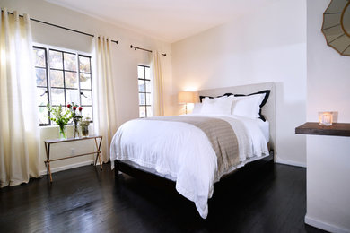Inspiration for a small industrial master dark wood floor and black floor bedroom remodel in Los Angeles with white walls