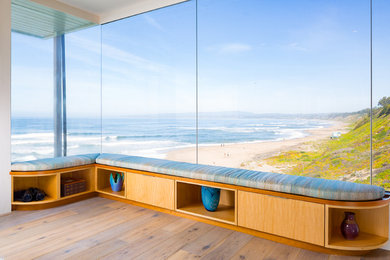 Example of a mid-sized beach style open concept medium tone wood floor and beige floor living room design in Other with white walls, no fireplace and no tv