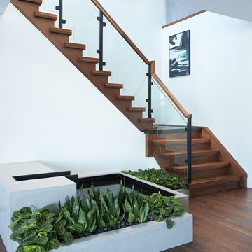 Steel and Concrete Mono Stringer with Clamped Glass Railing System