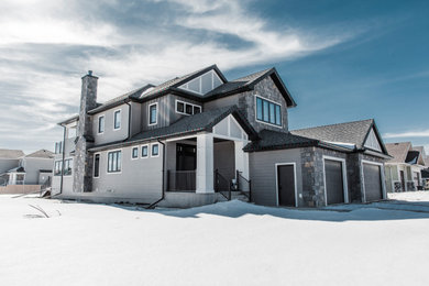 Mid-sized transitional gray two-story concrete fiberboard and board and batten exterior home photo in Edmonton with a shingle roof and a black roof