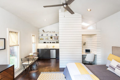 Trendy dark wood floor and brown floor bathroom photo in Austin with white walls