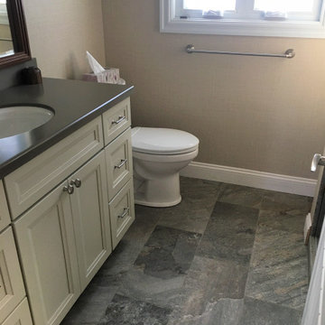 Earthy floor tile, Corian counter, grasscloth walls