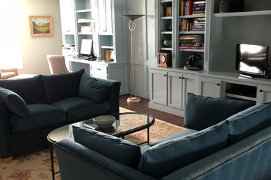 Family room library - mid-sized transitional loft-style dark wood floor family room library idea in DC Metro with blue walls, no fireplace and a media wall