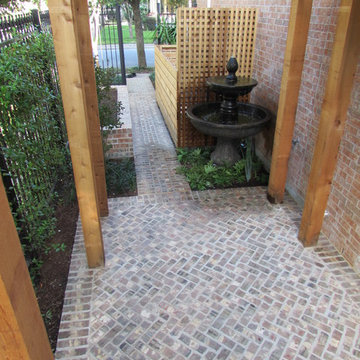 High function in a small side yard! Pergola, raised bed, mirrored wall, fountain