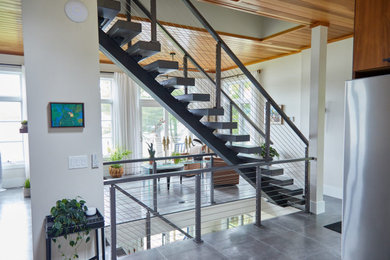 Entryway - mid-sized modern ceramic tile, gray floor and wood ceiling entryway idea in Other with white walls and a glass front door