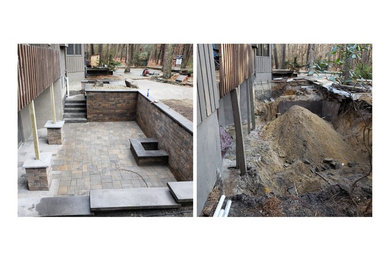 Example of a mid-sized classic backyard brick patio design in Philadelphia with a fireplace and no cover