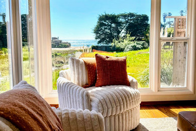 Inspiration for a mid-sized coastal open concept medium tone wood floor and brown floor living room remodel in San Francisco with beige walls, a standard fireplace and a stone fireplace