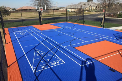 This is an example of a large traditional backyard outdoor basketball/tennis/multi-game court in Other.