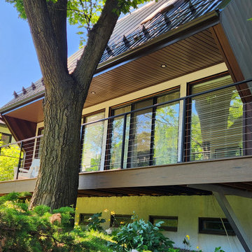 Deck with black metal post cable railing in Quebec, Canada