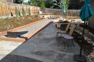 Inspiration for a large country backyard partial sun xeriscape in Denver with with path and natural stone pavers.