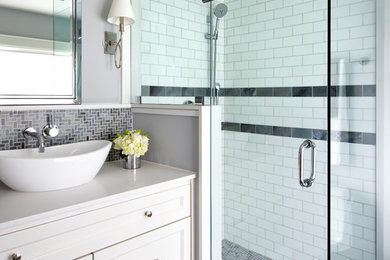 Inspiration for a small transitional master bathroom in Toronto with recessed-panel cabinets, white cabinets, a corner shower, gray tile, grey walls, a vessel sink, engineered quartz benchtops, mosaic tile and mosaic tile floors.