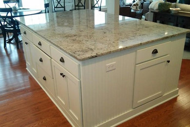 Inspiration for a large kitchen remodel in Minneapolis with flat-panel cabinets, granite countertops and an island