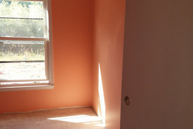 Inspiration for a bedroom remodel in Other with orange walls