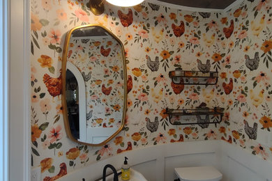 Inspiration for a small farmhouse light wood floor and wallpaper powder room remodel in Baltimore with a two-piece toilet, multicolored walls, a pedestal sink, quartz countertops and white countertops