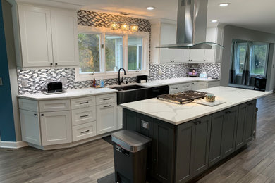 Large transitional kitchen photo in Chicago with recessed-panel cabinets and an island