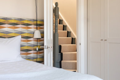 ロンドンにある中くらいなコンテンポラリースタイルのおしゃれな主寝室 (ベージュの壁、カーペット敷き、グレーの床) のインテリア