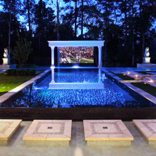 Photo of an expansive world-inspired open plan home cinema in Miami with terracotta flooring and a projector screen.