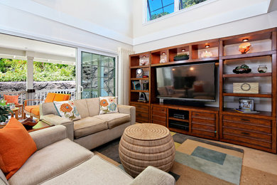 Mid-sized tropical formal living room in Hawaii with travertine floors, no fireplace, a wall-mounted tv and beige walls.