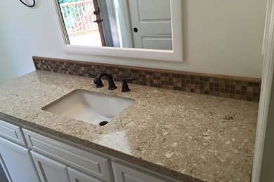 Mid-sized elegant 3/4 beige tile and ceramic tile porcelain tile and beige floor alcove shower photo in San Diego with recessed-panel cabinets, white cabinets, a one-piece toilet, beige walls, an undermount sink, quartzite countertops and a hinged shower door