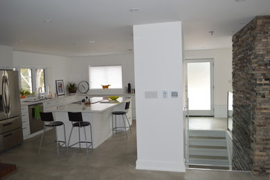 Inspiration for a modern eat-in kitchen remodel in Toronto with flat-panel cabinets and white cabinets