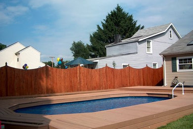 Inspiration for a mid-sized timeless backyard custom-shaped lap pool remodel in Philadelphia with decking