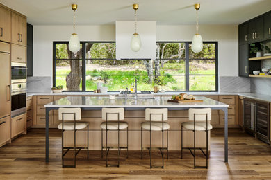Inspiration for a contemporary eat-in kitchen remodel in Austin with marble backsplash, stainless steel appliances, an island and white countertops