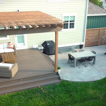 Combination backyard project featuring deck, pergola, and patio pavers