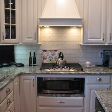 Medium color wood to off white with white subway tile and granite counter tops